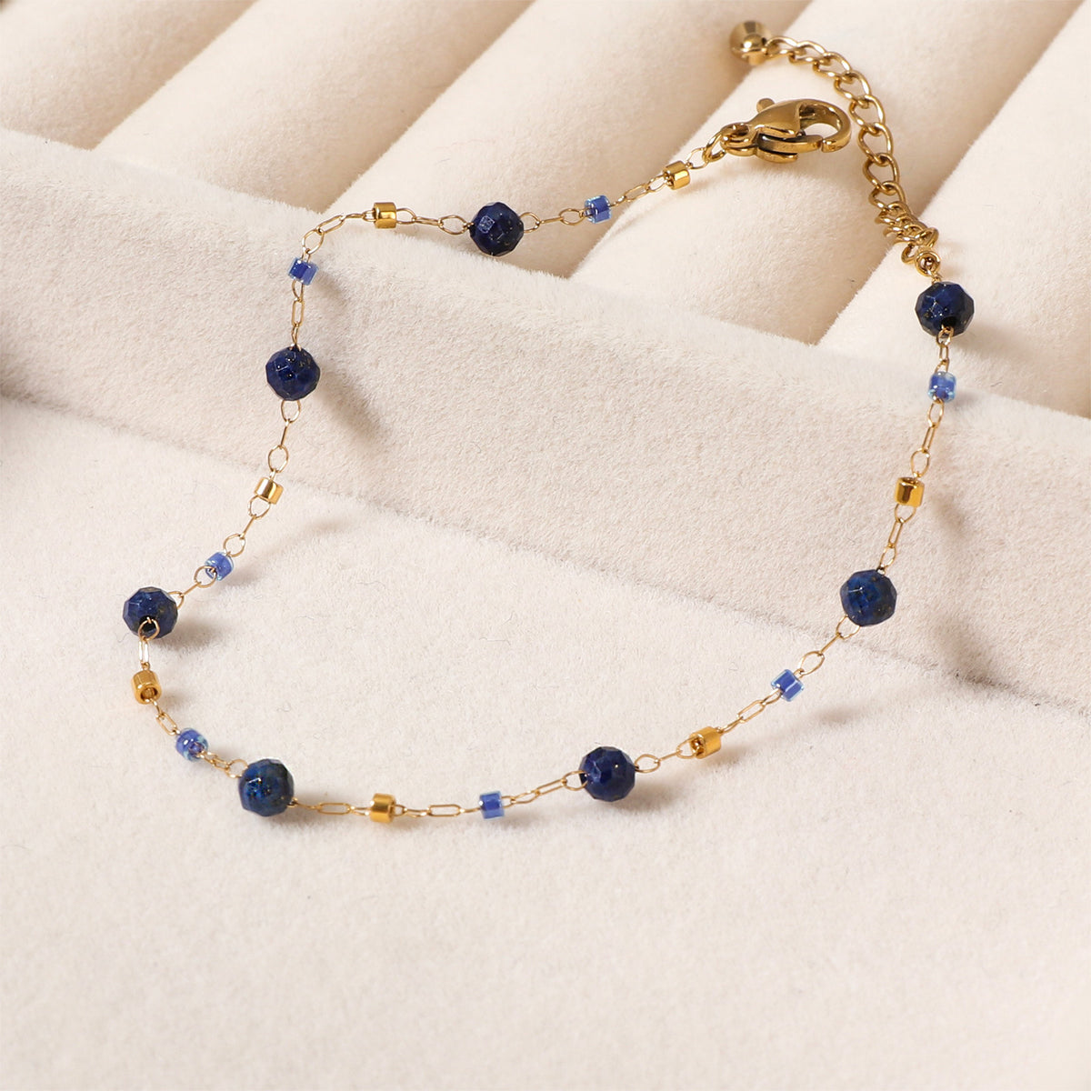 Deep blue bead chain bracelet with gold-tone clasp and extender