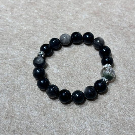 Green and silver sheen bead bracelet on white