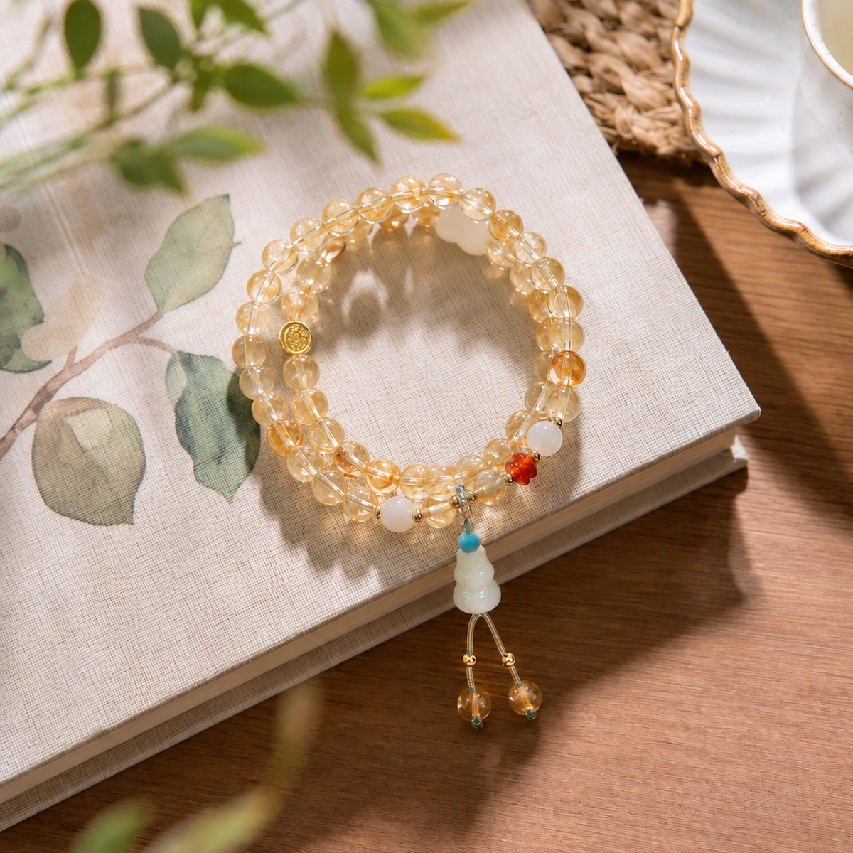 Golden crystal bead bracelet styled on an open book