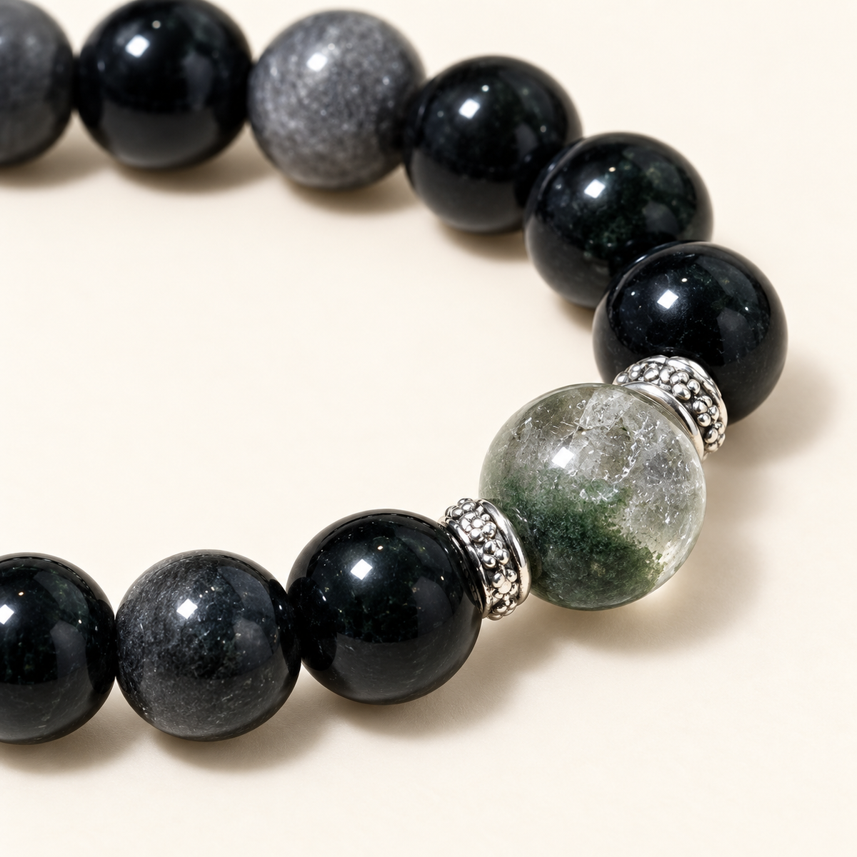 Close-up of green and silver-sheen beads with the clear green focal bead