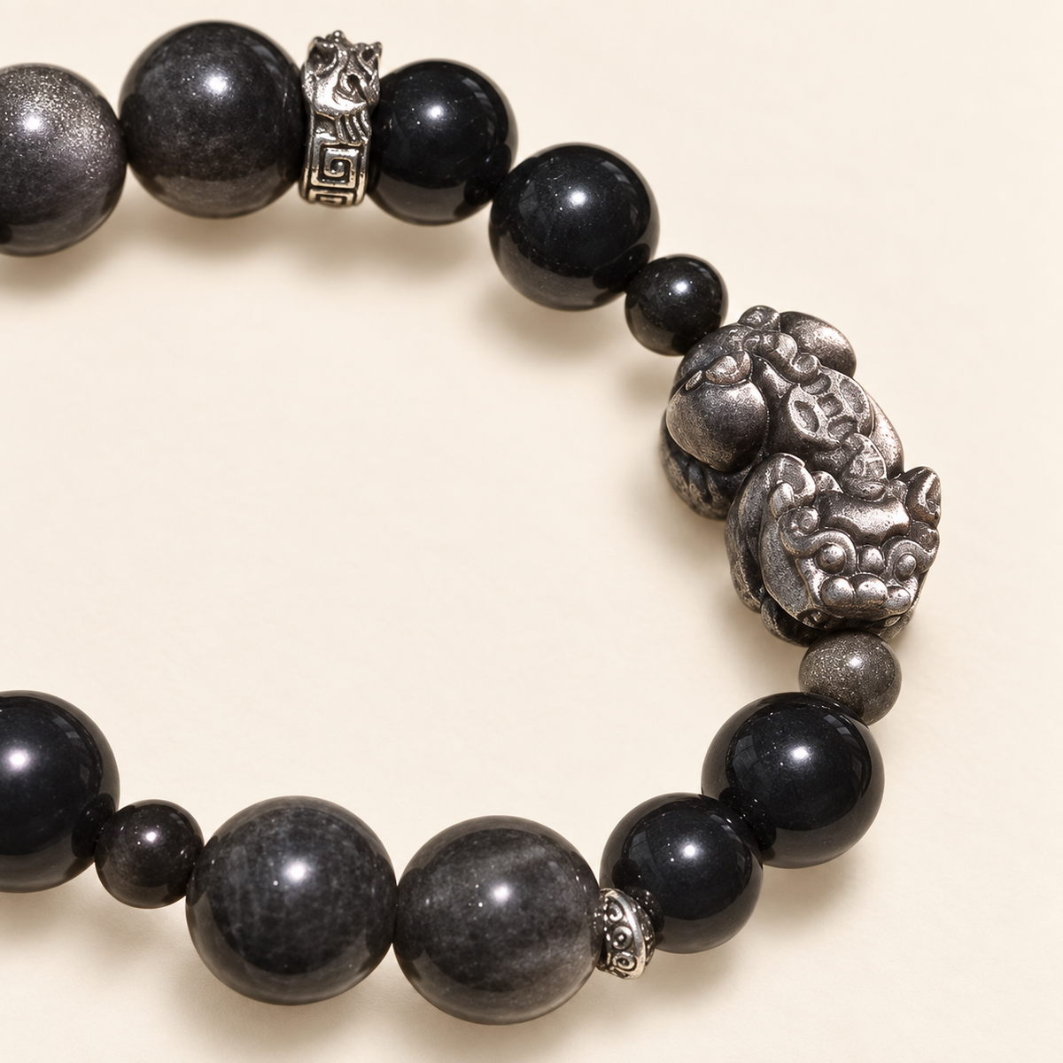 Close-up of the Pixiu-inspired centerpiece and mixed-size dark beads
