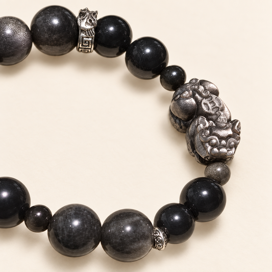 Close-up of the Pixiu-inspired centerpiece and mixed-size dark beads